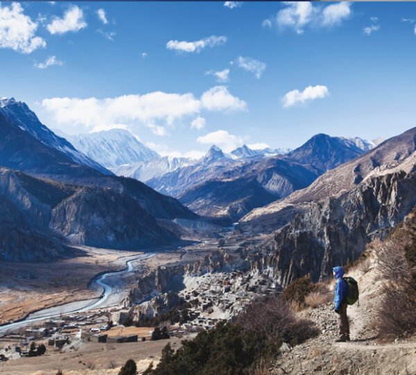 Elevate Trek- Backpacker relishing a stunning landscape view during Annapurna Base Camp Trek