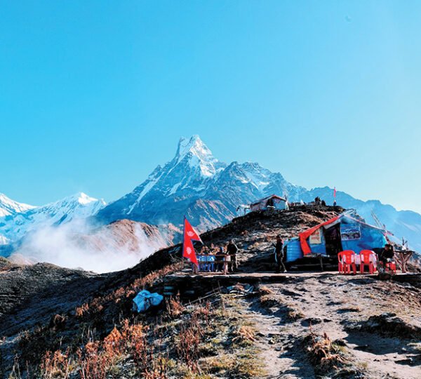 Elevate Trek - At the summit of Mardi Himal Trek, and Nepali Flag waving aside