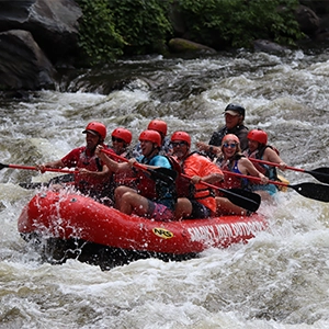 Elevate Trek- A group of adventurous rafters navigating white water rapids on the Upper Seti River