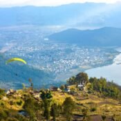 Elevate Trek- Paragliders soaring high above the beautiful landscape of Pokhara.