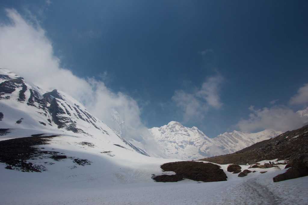 Breathtaking view of the snow-covered Annapurna mountain range in Nepal, under a clear blue sky.