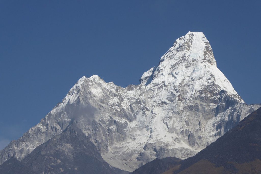 Majestic Mount Ama Dablam in Nepal, a striking snowy peak under clear blue skies.