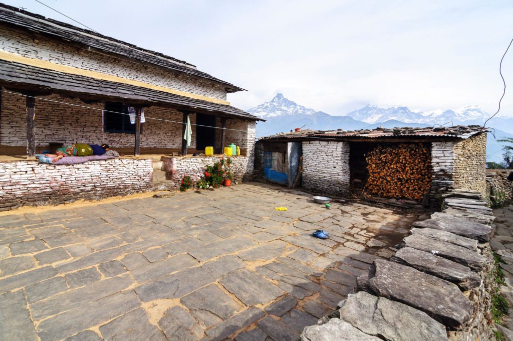 Scenic traditional village home in Dhampus, Nepal with Himalayan backdrop.