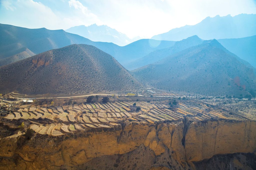 Explore the majestic terraced landscape of Lo Manthang in Nepal, showcasing its natural beauty.